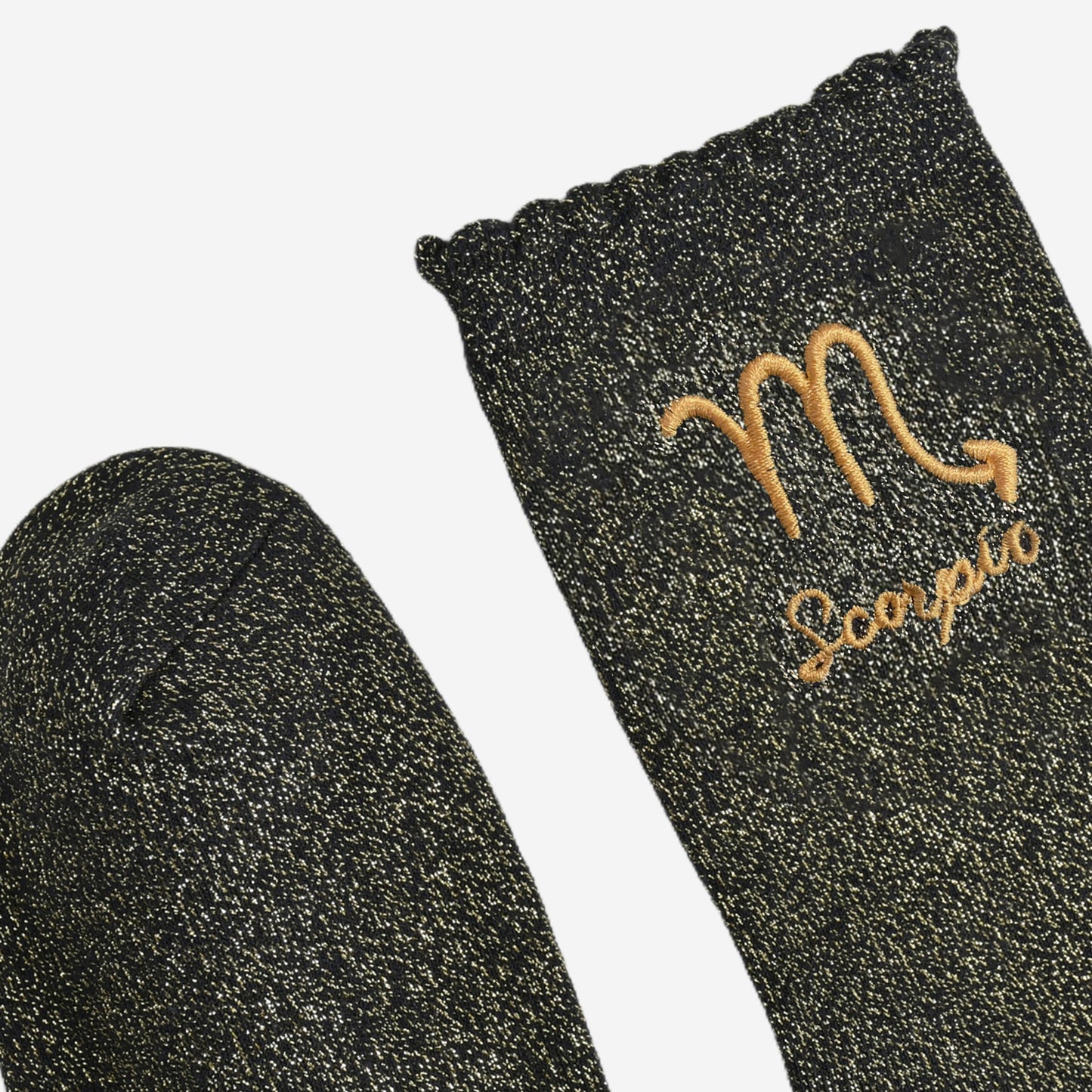 showing the toe and cuff of the socks, they are the same black and gold sparkly colour as the body of the socks, the cuff is scalloped shaped like a slight frill