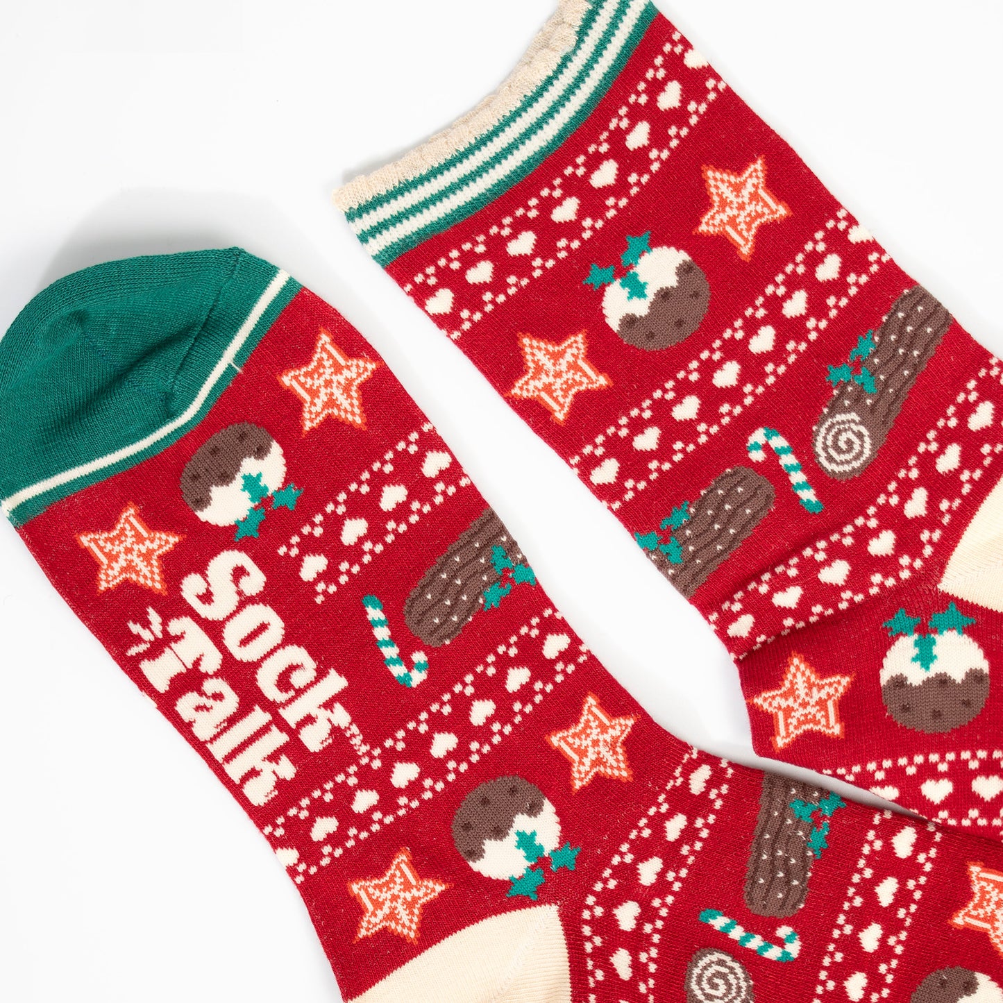 close up of the toe and cuff, the toe is green with a cream border stripe, the cuff is scalloped with cream and green stripes