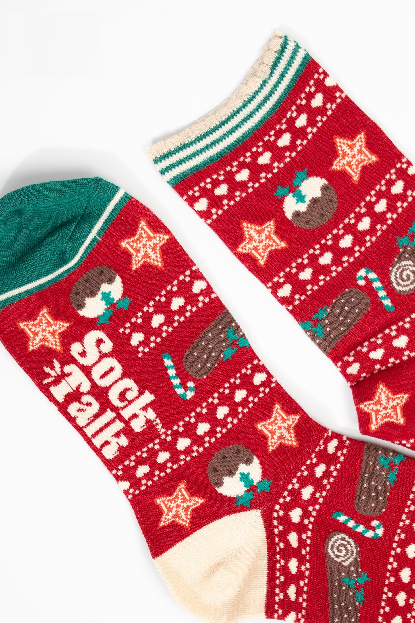 close up of the toe and cuff, the toe is green with a cream border stripe, the cuff is scalloped with cream and green stripes