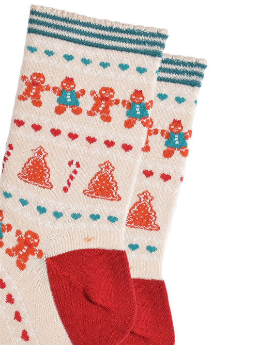 close up of the fair isle pattern, there are rows of gingerbread cookies men and women side by side, rows of red and green love hearts and rows of gingerbread xmas trees and candy canes.