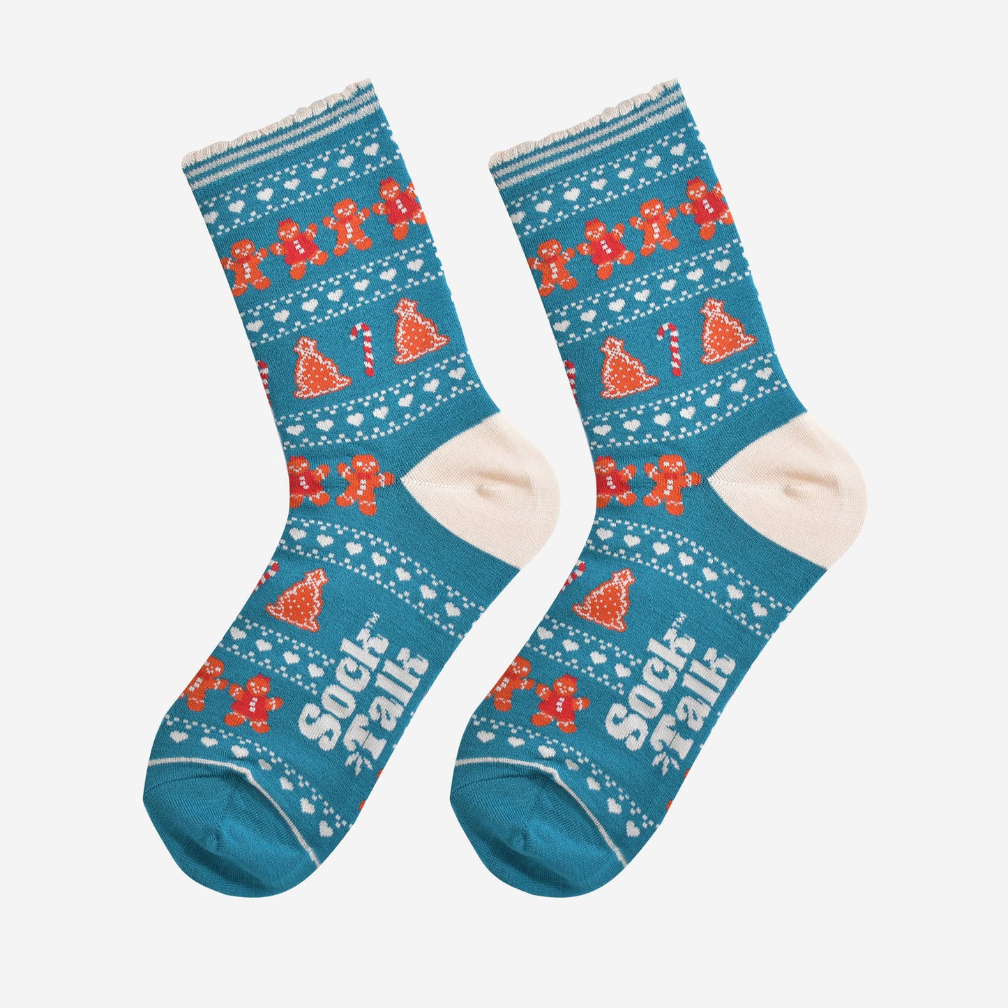 showing the festive gingerbread socks laying flat, the fair isle pattern is all over the socks and features gingerbread men, gingerbread women, gingerbread xmas tree cookies, candy canes and love hearts