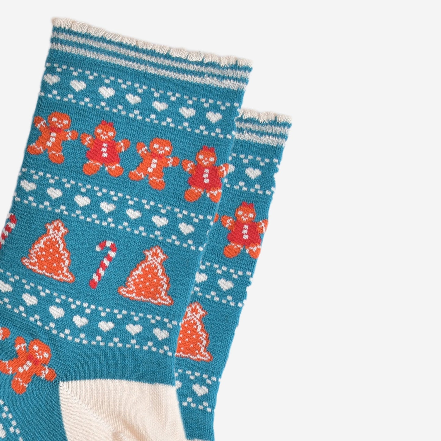 close up of the fair isle pattern, there are rows of gingerbread cookies men and women side by side, rows of white love hearts and rows of gingerbread xmas trees and candy canes.