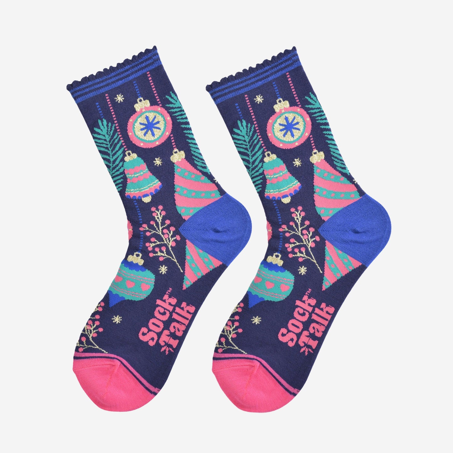 christmas tree bauble socks laying flat, showing an all over colourful design in blue, green and pink. there are festive baubles, xmas tree bells, small tree branches and berries.