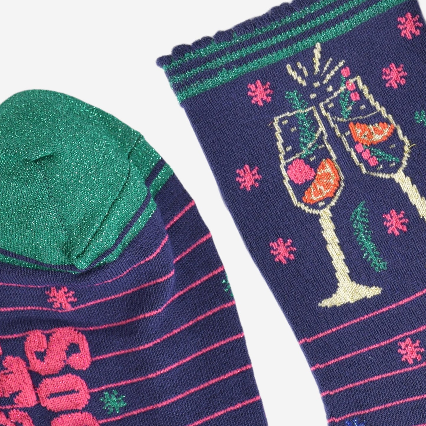 close up of the sparkly green toe and scalloped navy and green stiped cuff