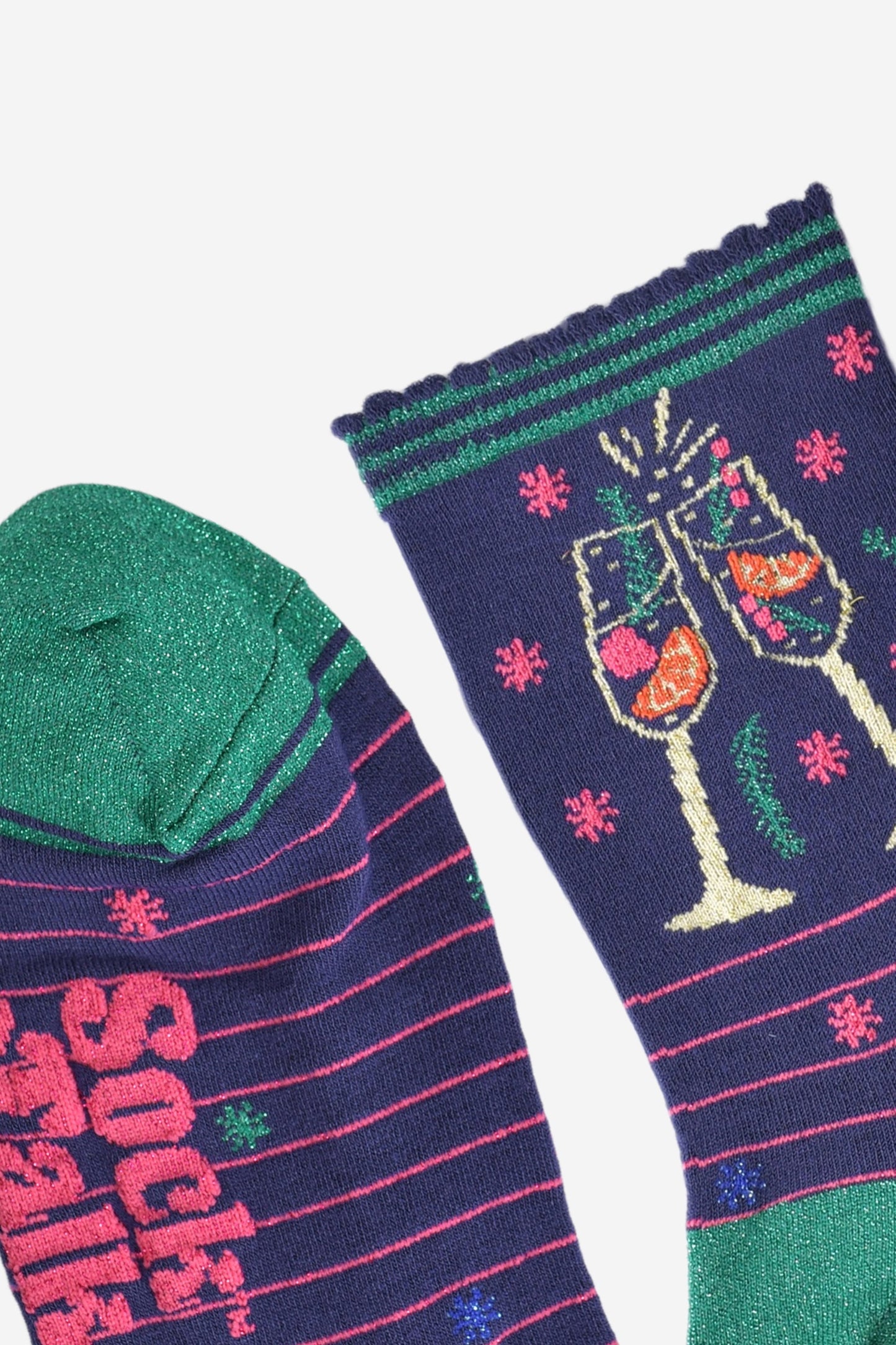 close up of the sparkly green toe and scalloped navy and green stiped cuff