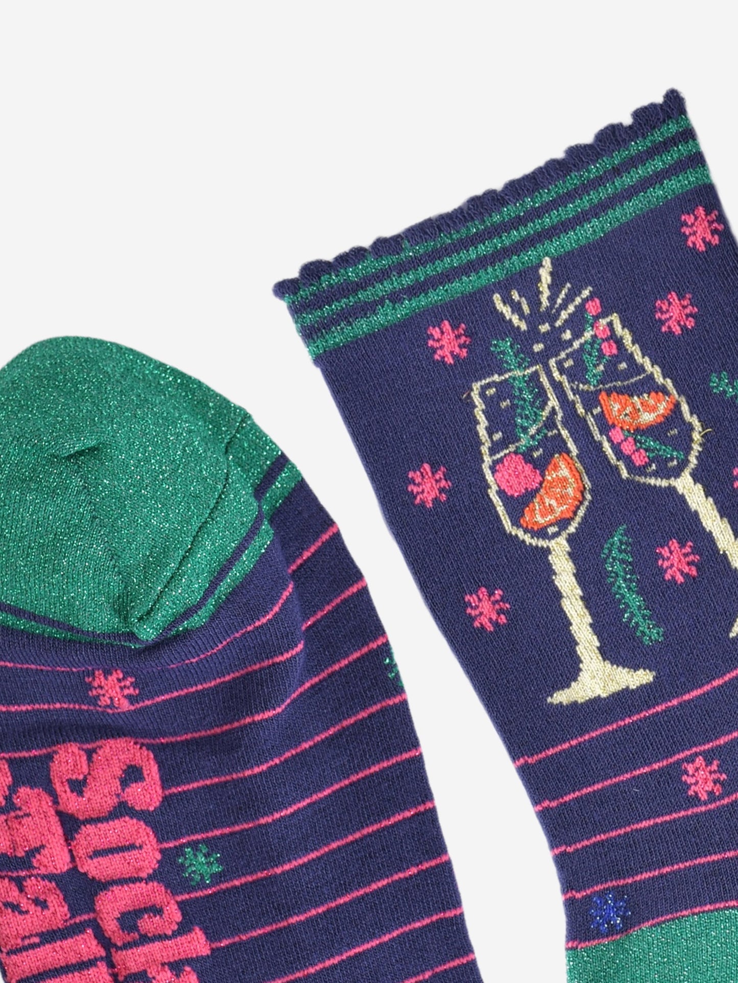 close up of the sparkly green toe and scalloped navy and green stiped cuff