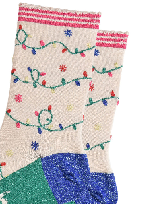 close up of the multicoloured party light design on the socks, the lights are attached to a green string and wrap around the socks, the socks have sparkly glitter accents