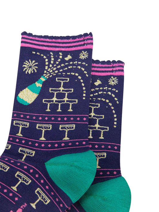 navy blue socks with a pattern of popping champagne bottles and vintage coupe glasses, the socks have a pink striped scalloped cuff