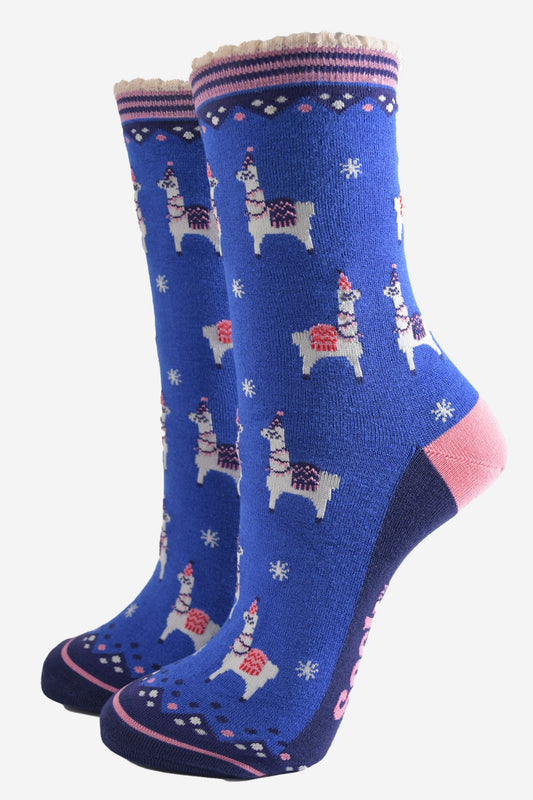 red bamboo socks with a navy striped cuff featuring a pattern of llamas wearing party hats and party lights