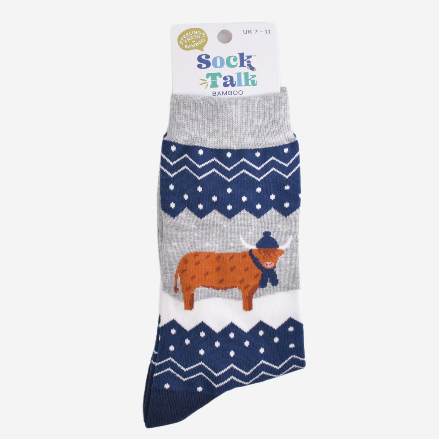 blue and grey fair isle highland cow socks in their sock talk packaging, these socks are a uk size 7-11