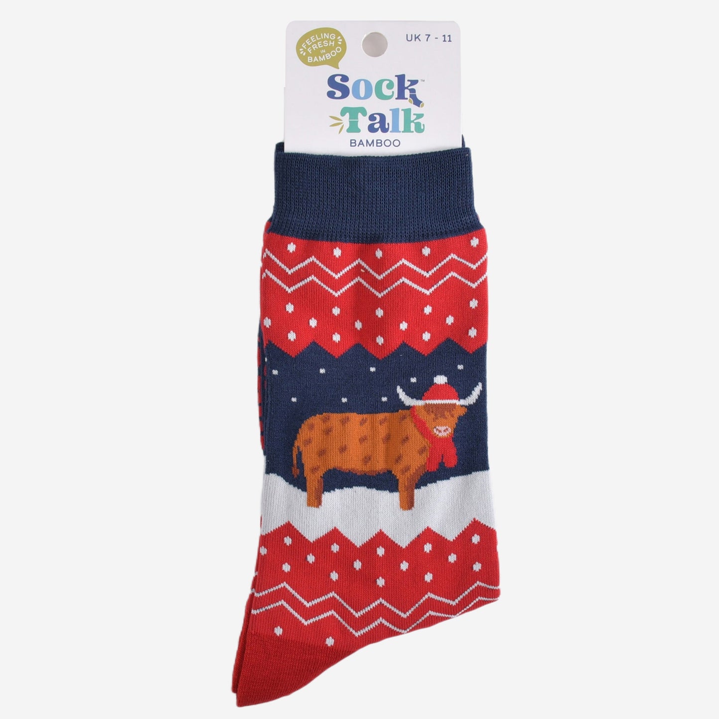 navy blue and red fair isle highland cow socks in their sock talk packaging, these socks are a uk size 7-11