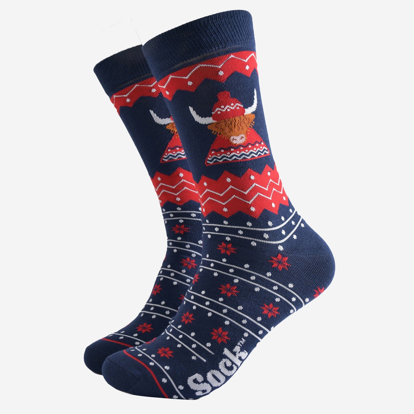 navy blue and red fair isle socks featuring a highland cow wearing a traditional knitted fair isle hat and jumper