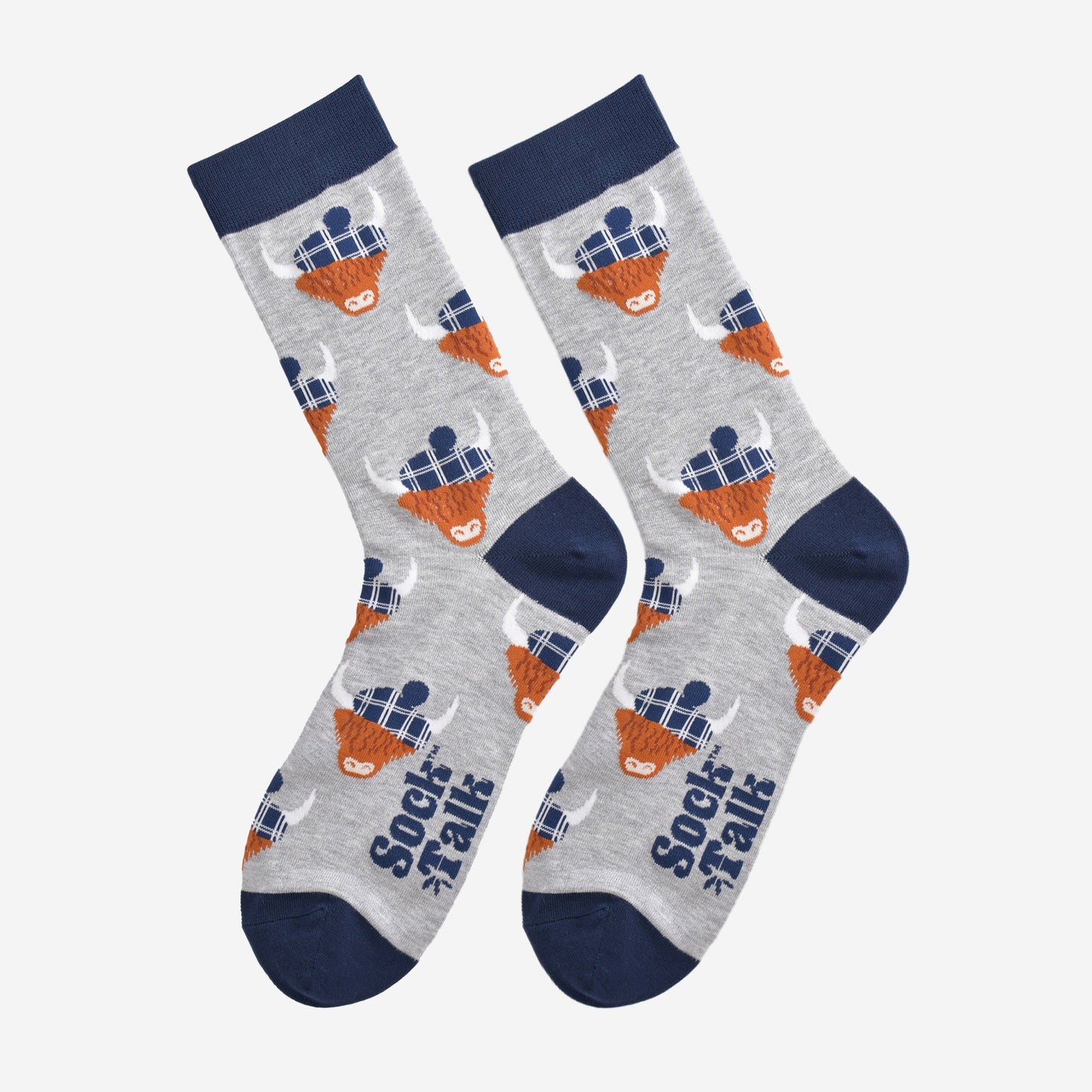 grey and navy blue highland cow bamboo socks laying flat, the highland cows are wearing blue tartan hats