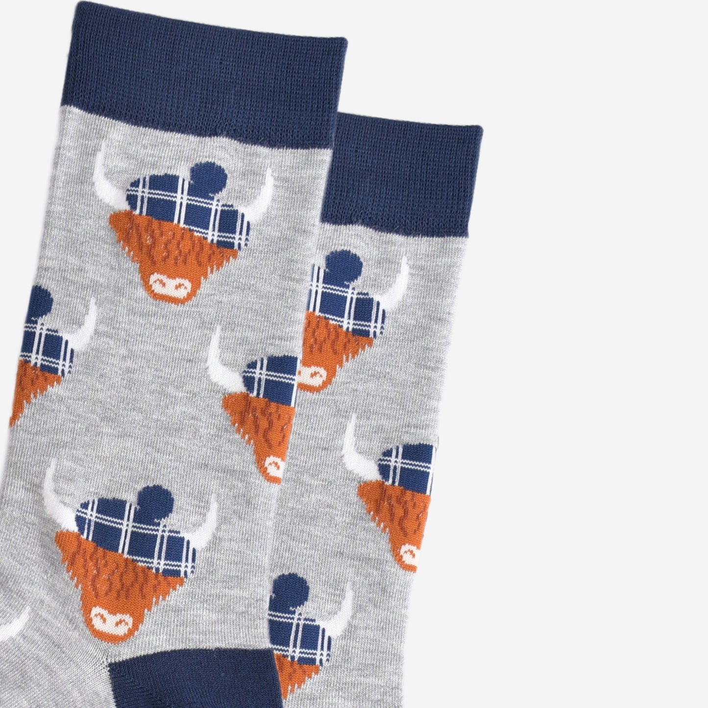 close up of the highland cow pattern, showing clearly the blue tartan hats they are wearing