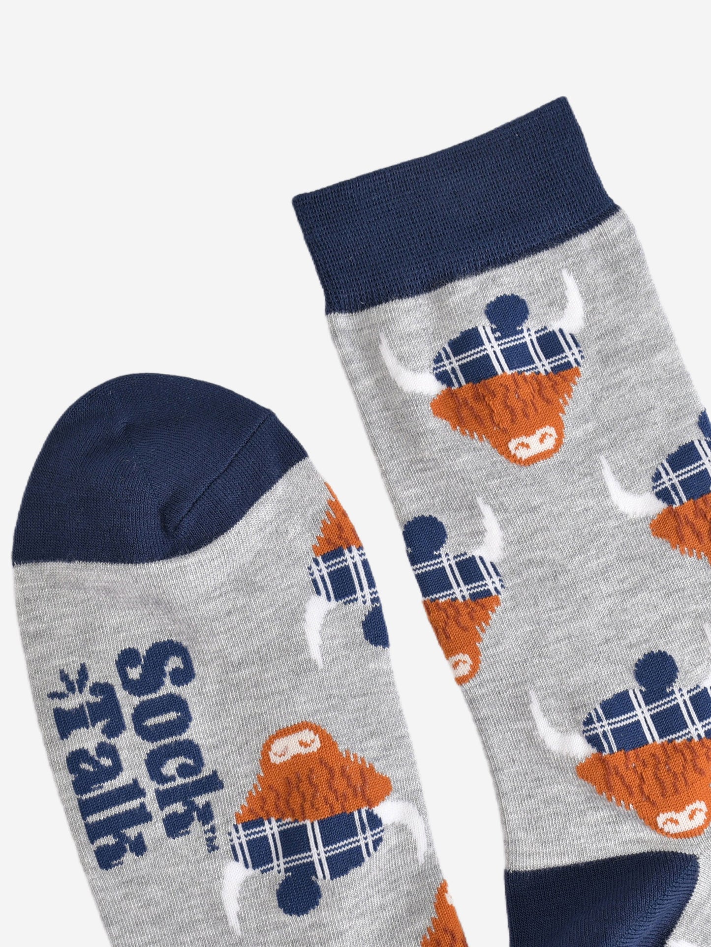 showing the toe and cuff of the grey and navy blue scottish highland cow socks