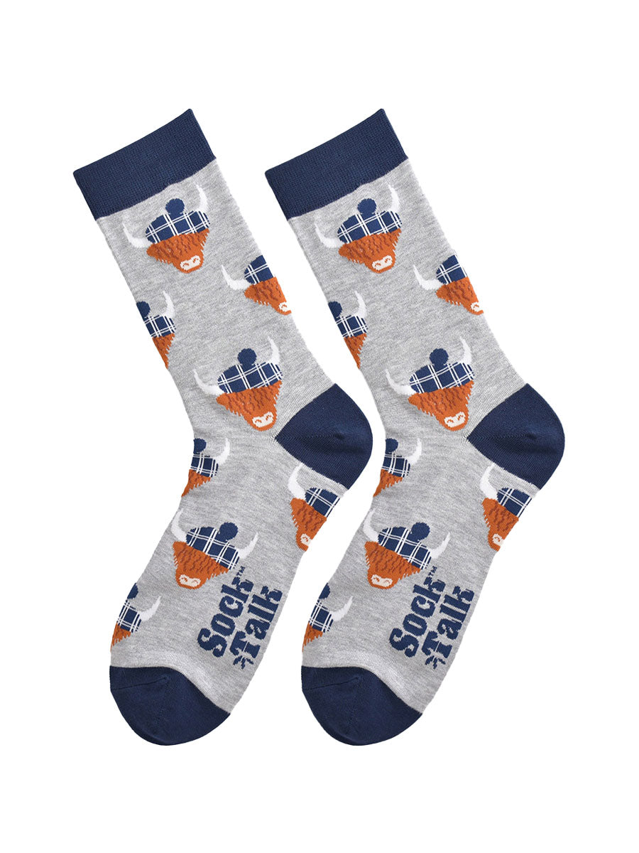 grey and navy blue highland cow bamboo socks laying flat, the highland cows are wearing blue tartan hats