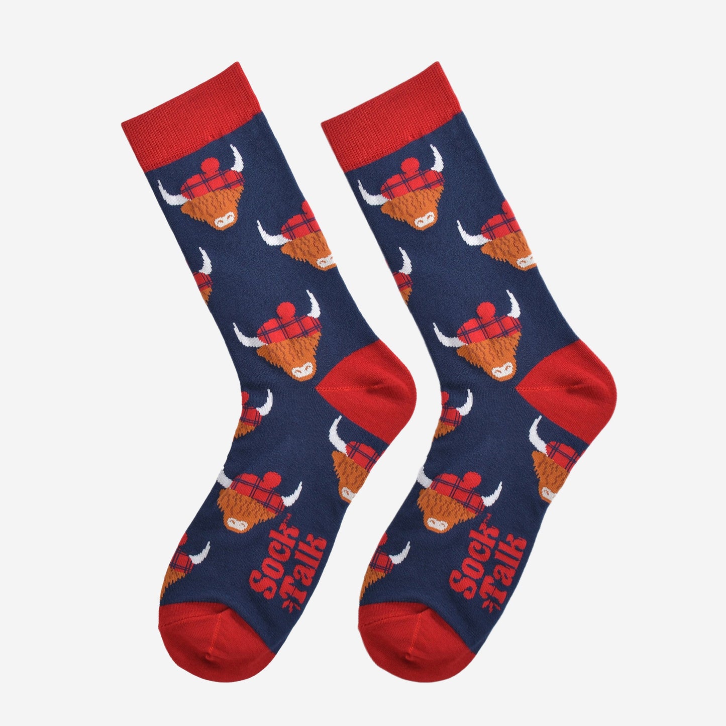 navy blue highland cow bamboo socks laying flat, the highland cows are wearing blue tartan hats
