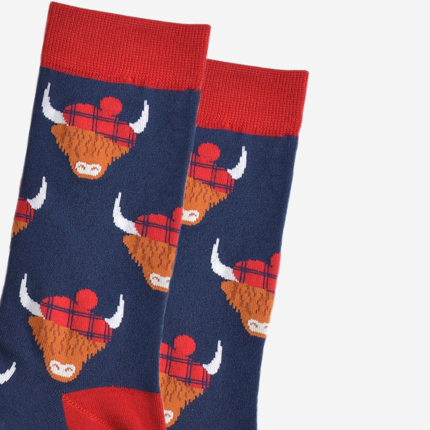 close up of the highland cow pattern, showing clearly the red tartan hats they are wearing