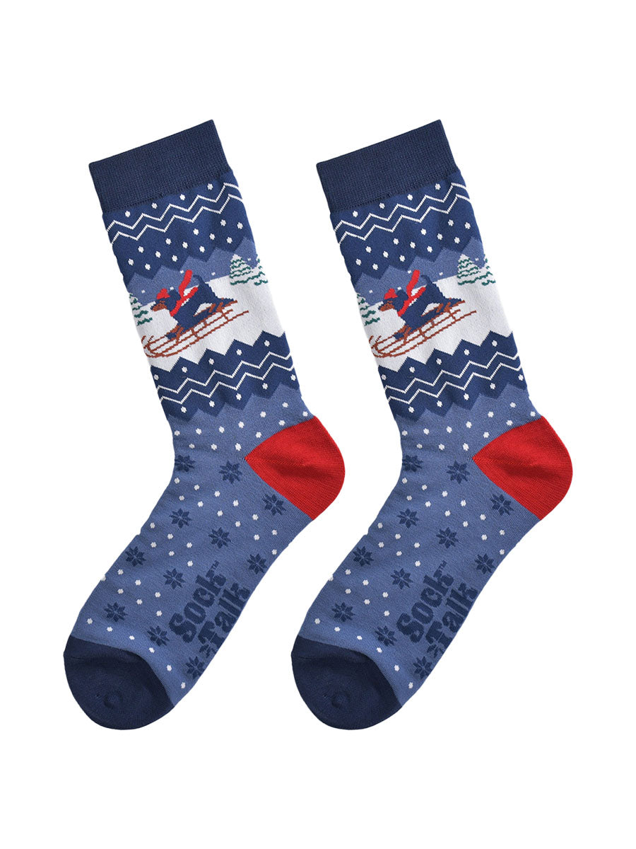 sledging sausage dog socks laying flat, showing the fair isle pattern and winter scene