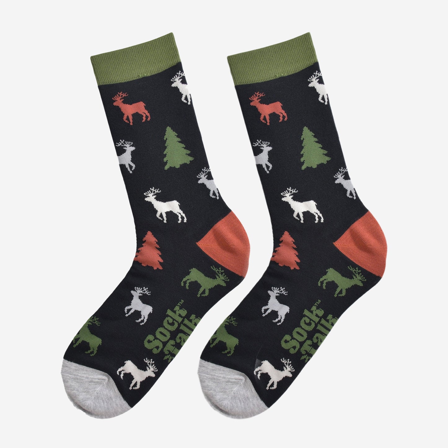 showing the stag and christmas tree socks laying flat, the reindeer are orange, green, grey and white, the trees are green and orange all on a black back ground