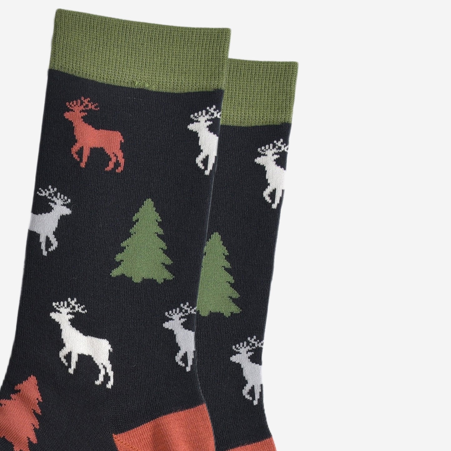 close up of the stag and xmas tree pattern, the stage are stading and profile and have clearly defined antlers