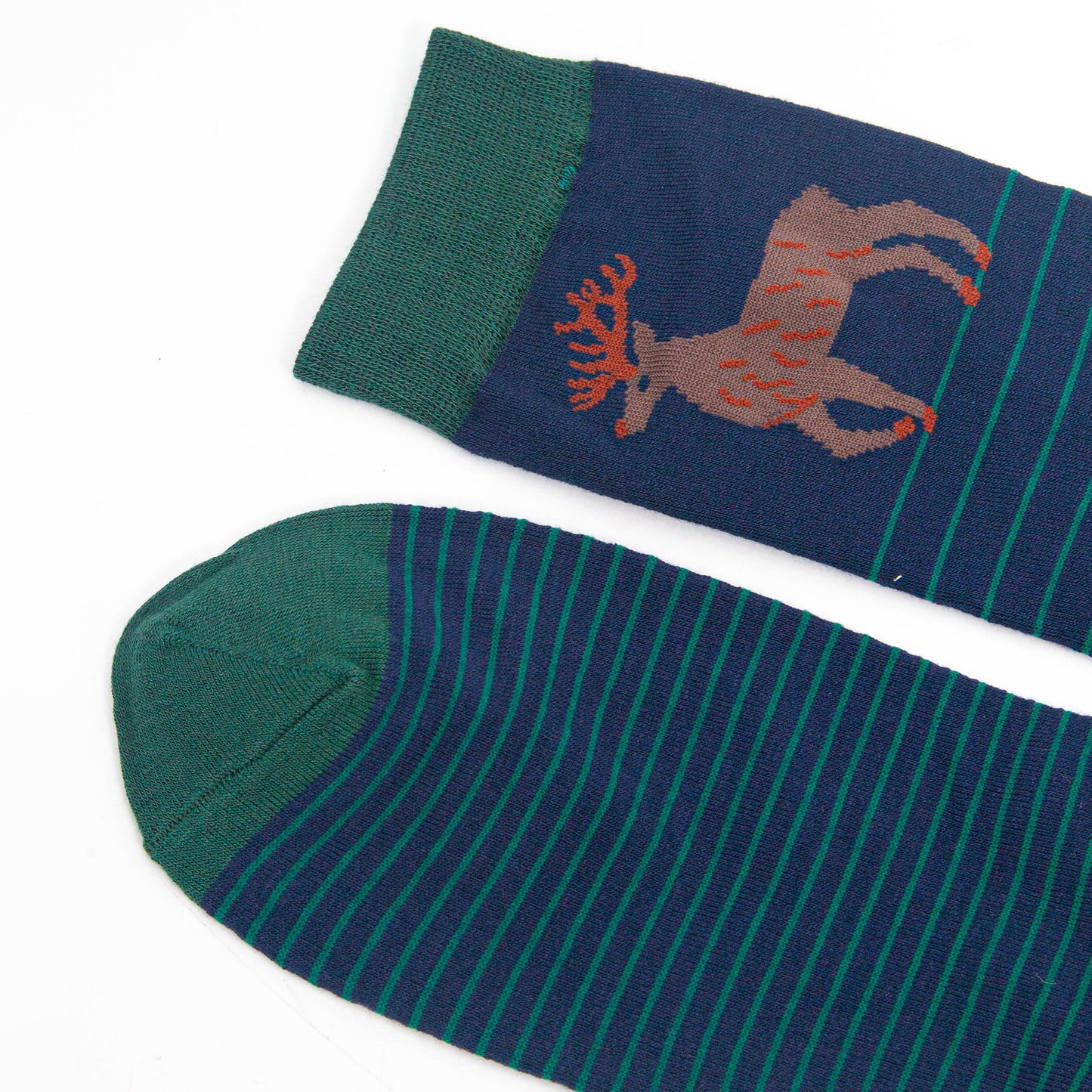 close up of the toe and cuff, both are green in contrast to the navy blue base of the socks
