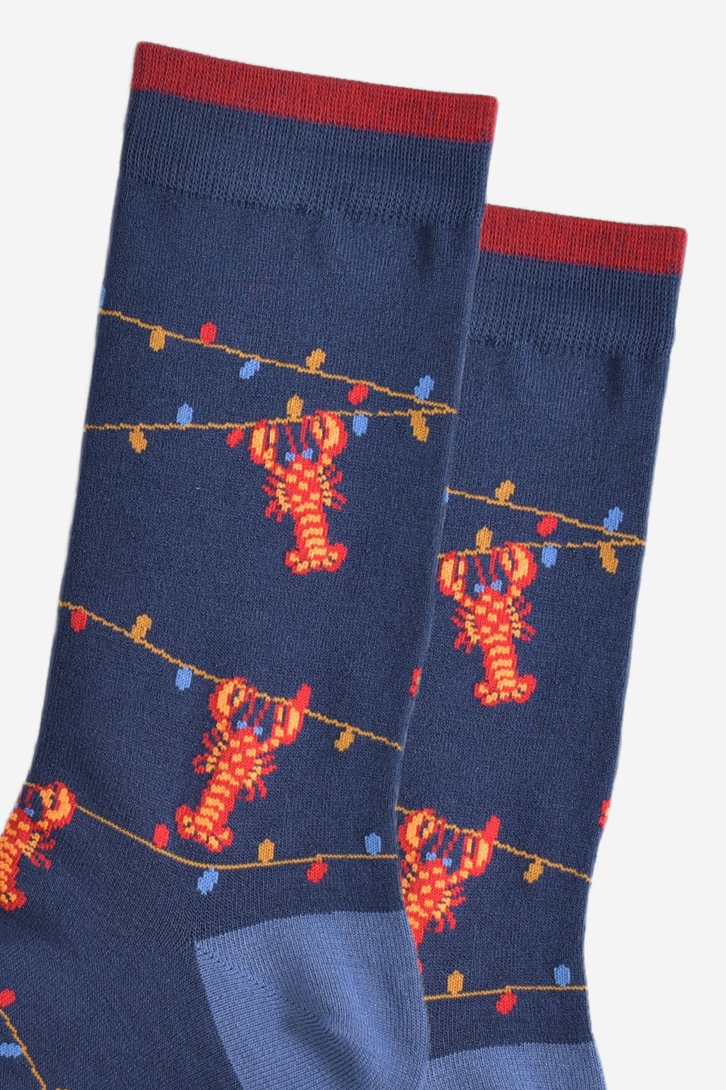 close up of the lobster and party light pattern on the bamboo socks, showing the colourful party lights