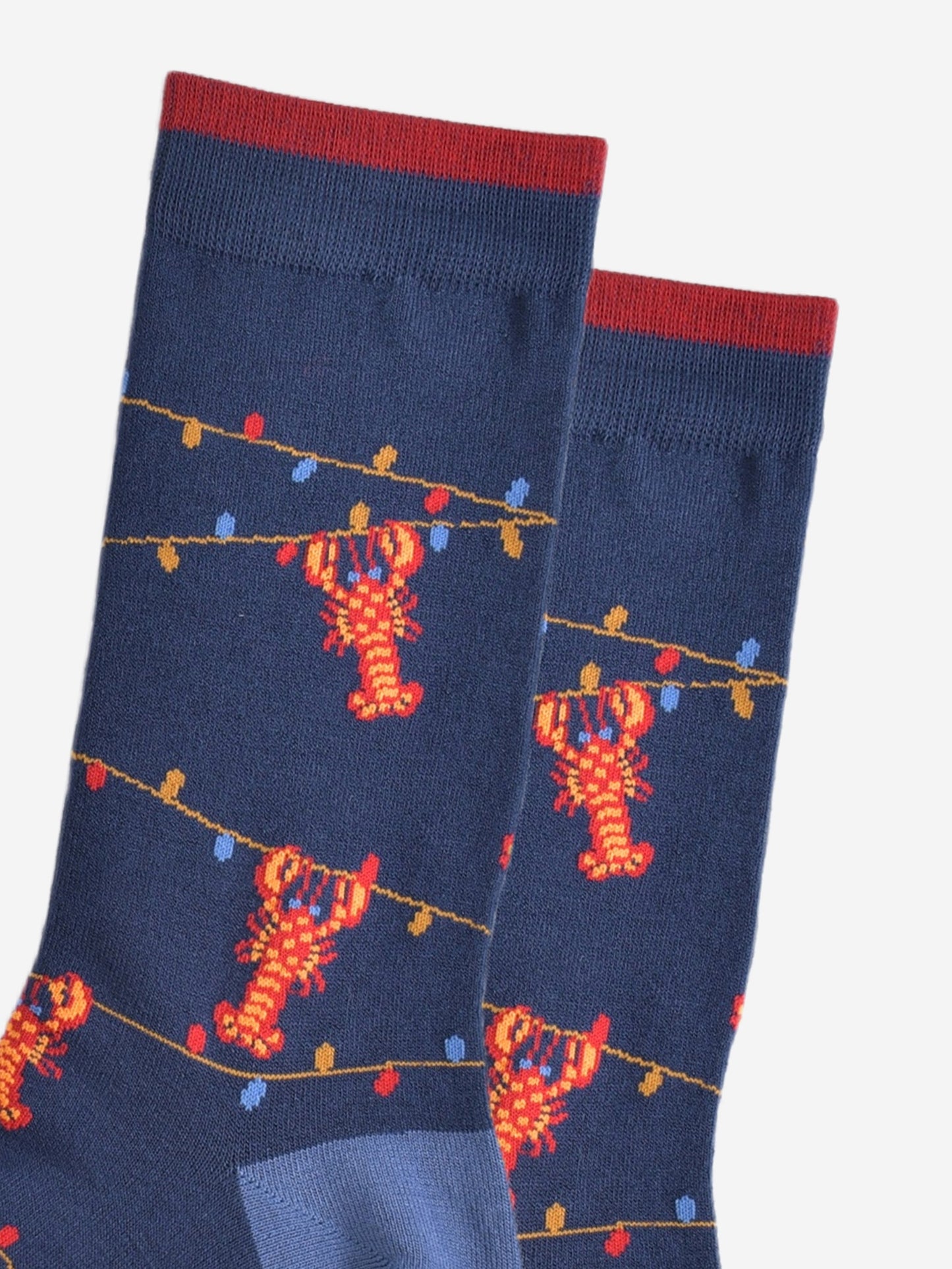 close up of the lobster and party light pattern on the bamboo socks, showing the colourful party lights