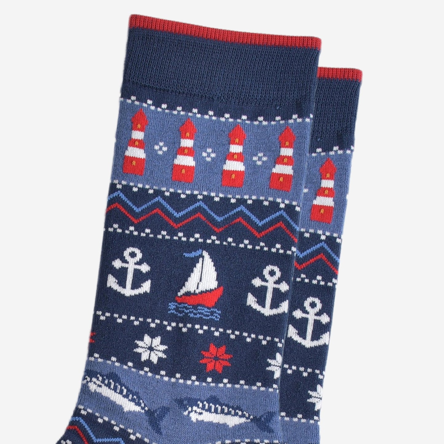 close up of the nautical designs on the socks, the lighthouses, boats, anchors and fish are shown