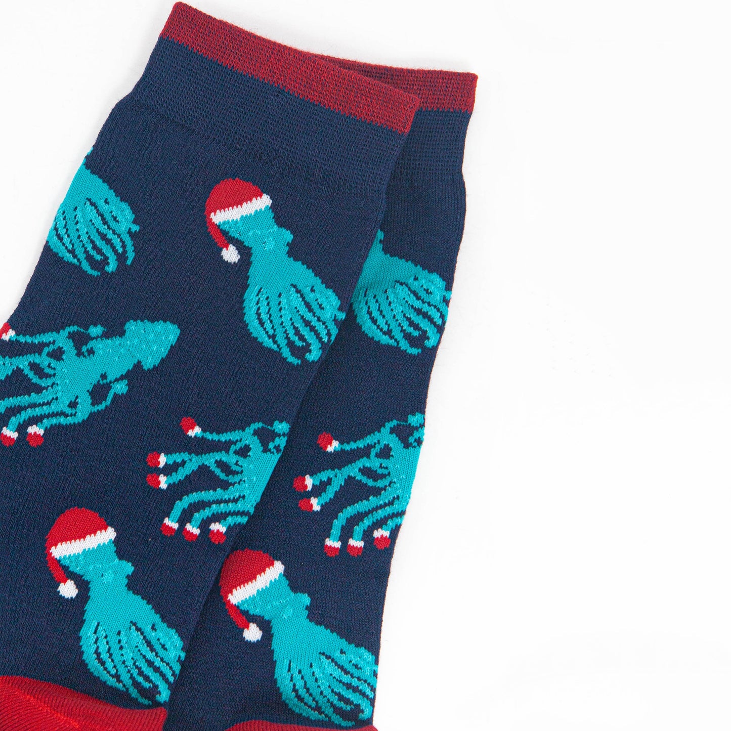 close up of the squid and octopus pattern, the octopus are wearing santa hats, the squid are wearing santa slippers on the ends of their tentacles