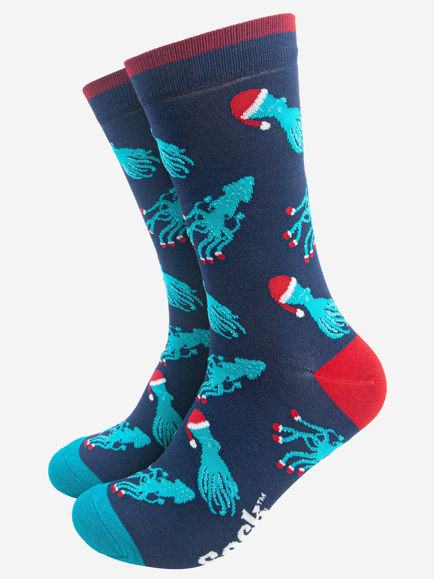 navy blue socks with an all over pattern of electric blue squid and octopus wearing santa hats