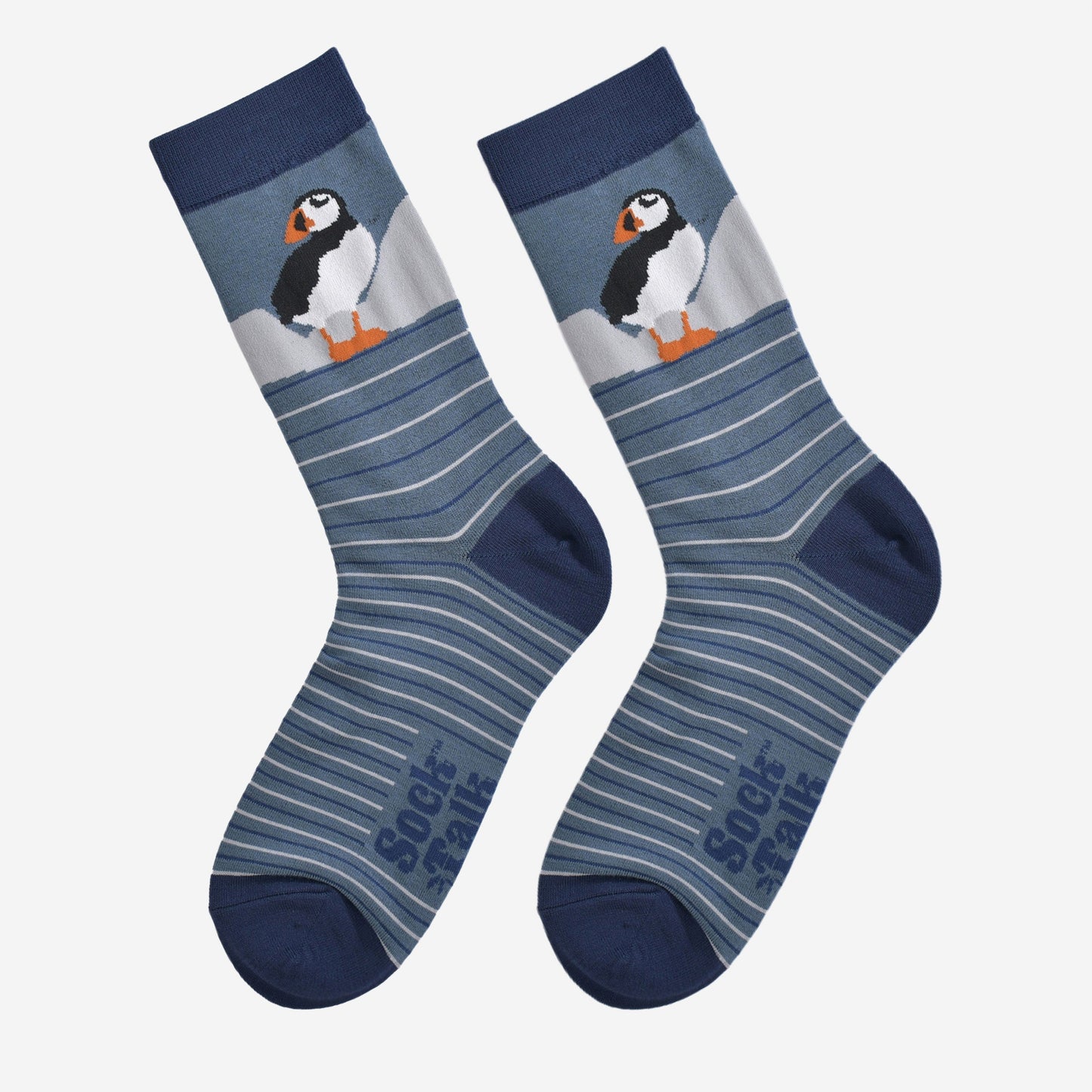 showing the striped puffin socks laying flat, showing the grey and blue stripes and the puffin design on the ankle.