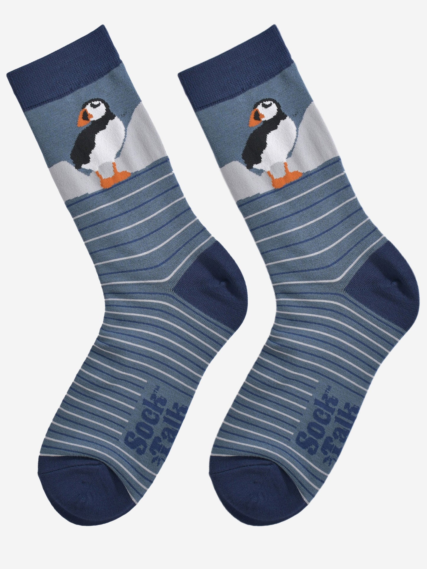 showing the striped puffin socks laying flat, showing the grey and blue stripes and the puffin design on the ankle.