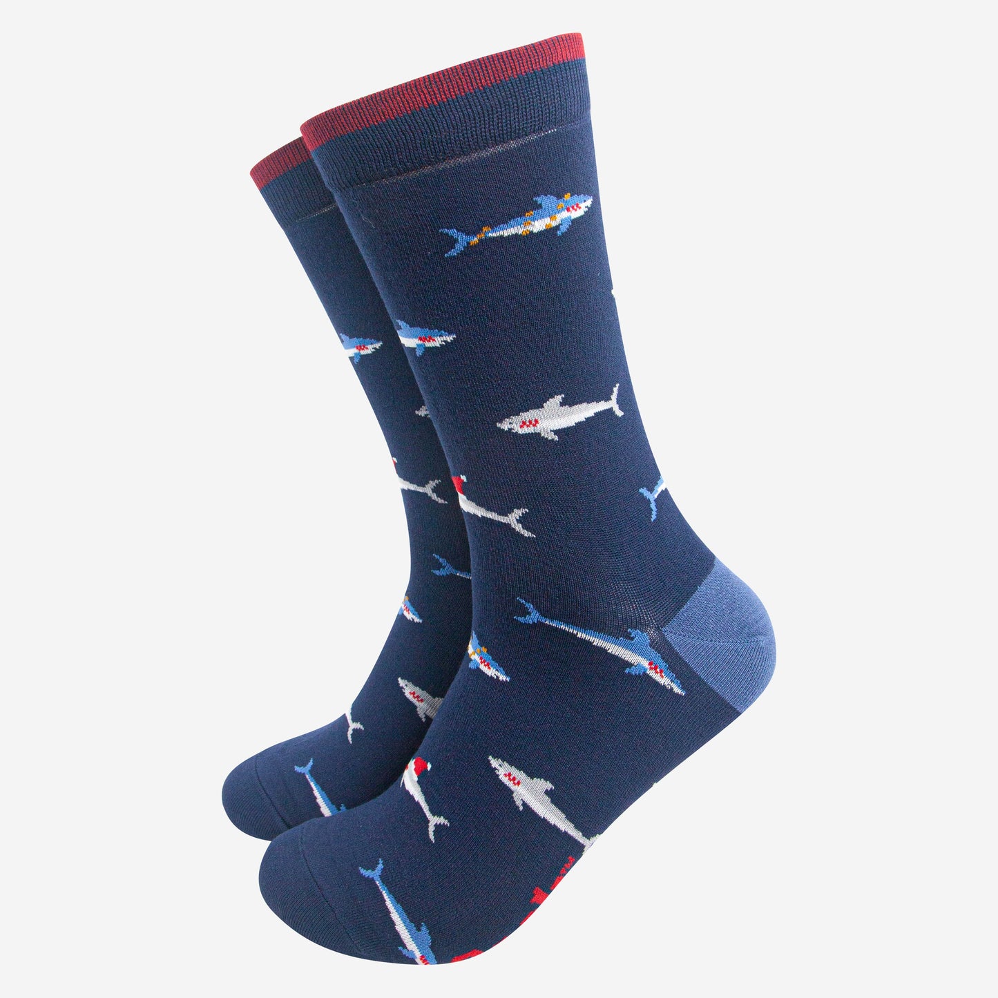 navy blue bamboo socks with a pattern of swimming sharks wearing santa hats