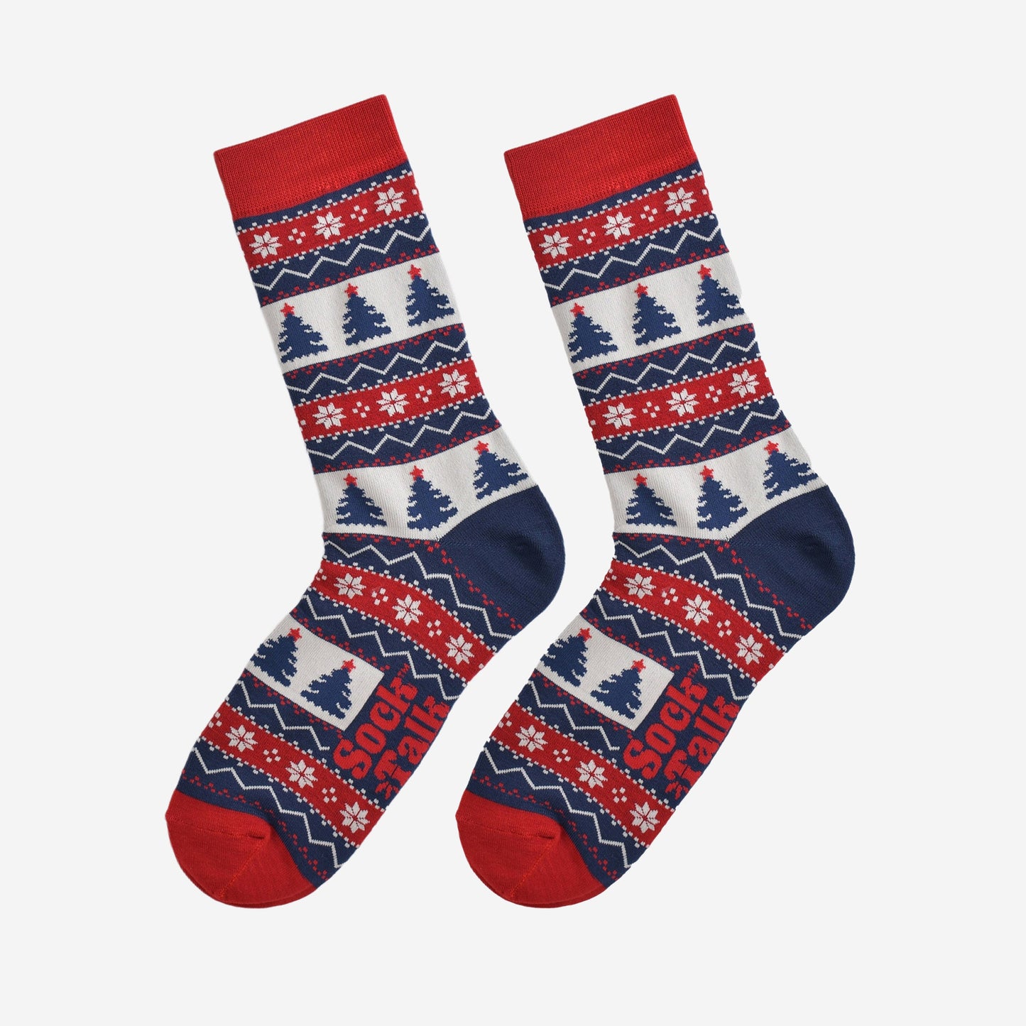 fair isle christmas tree socks laying flat, showing the all over pattern featuring snow flakes, xmas tress and zig zag patterns
