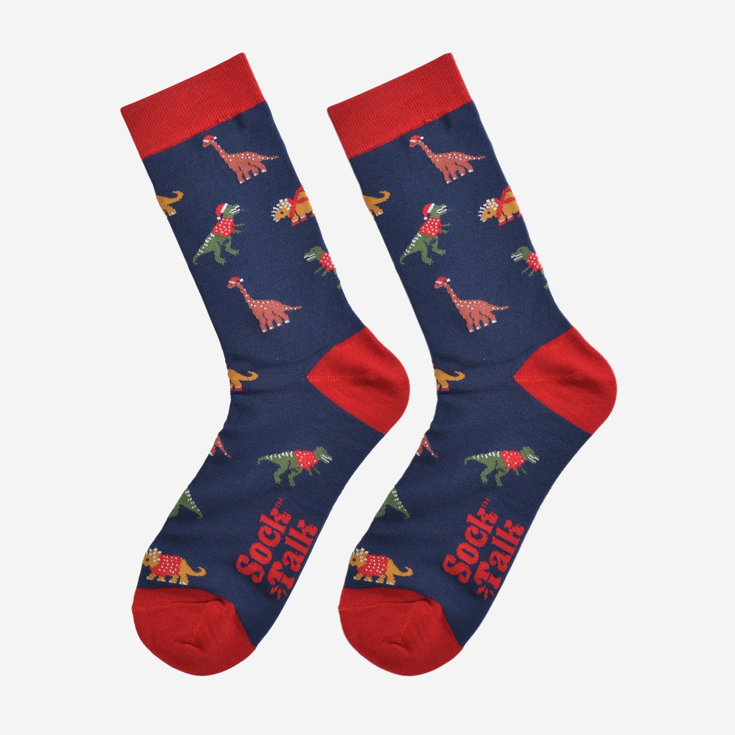 christmas dinosaur bamboo socks laying flat, showing the all over festive pattern of colourful dinosaurs wearing xmas hats and jumpers