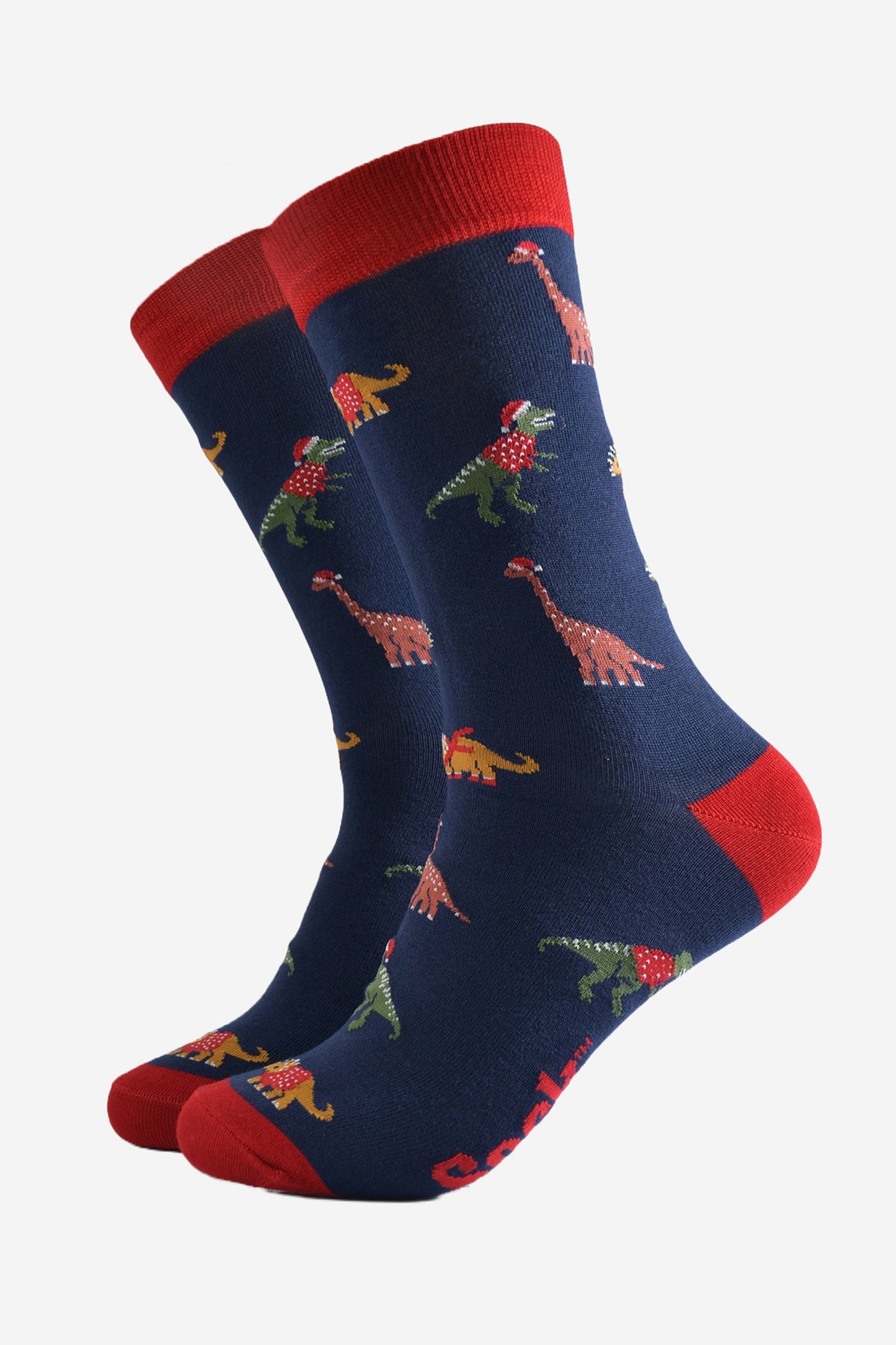 navy blue dress socks with a red heel, toe and cuff with a pattern of colourful dinosaurs wearing santa hats