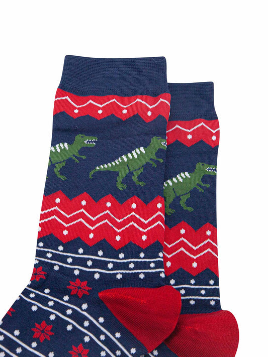close up of the t-rex dinosaurs on the ankle of the socks, the dinos are green with white stripes on their backs