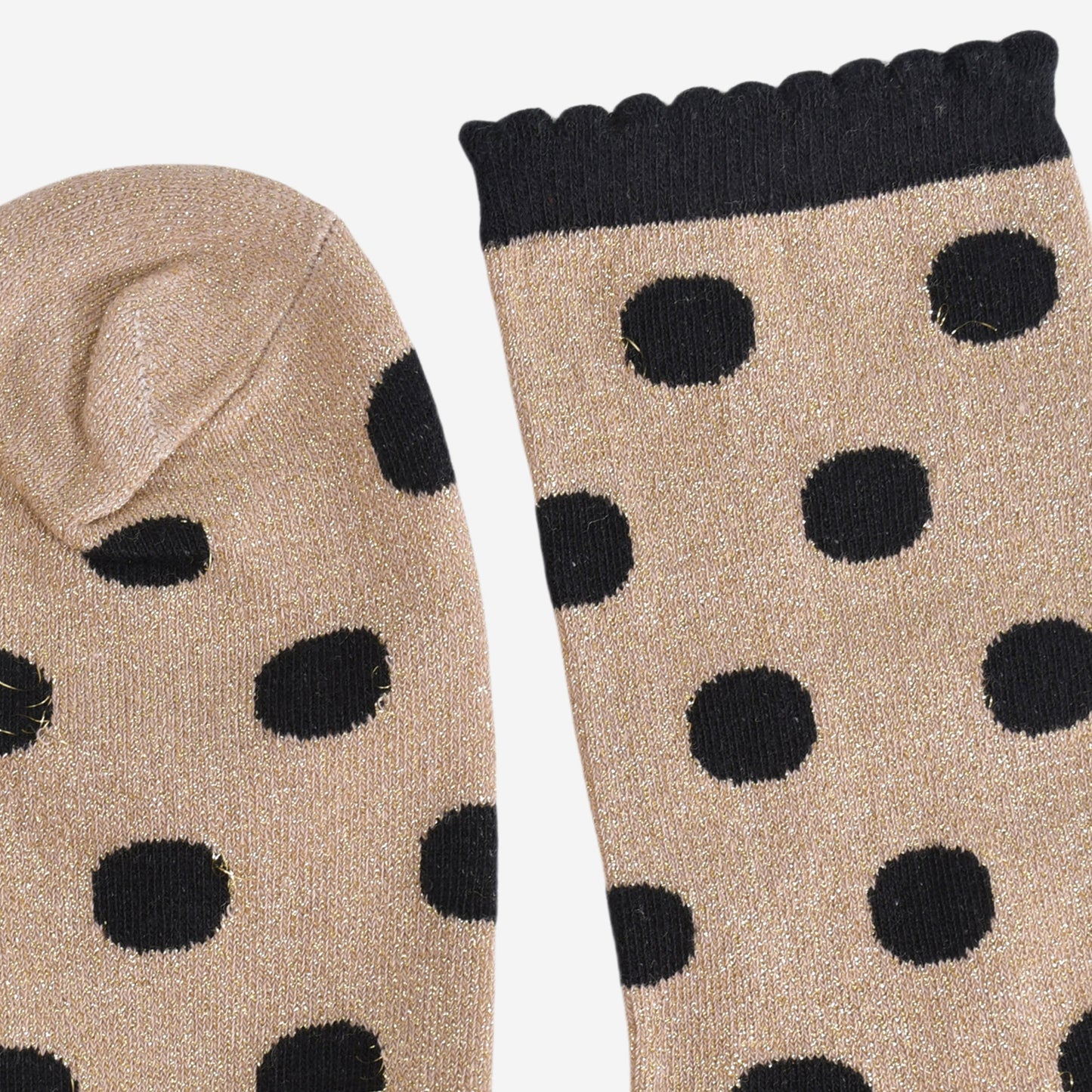 close up of the toe and cuff, the toe is gold with silver sparkles like the base of the socks, the cuff is black and has a scalloped edge