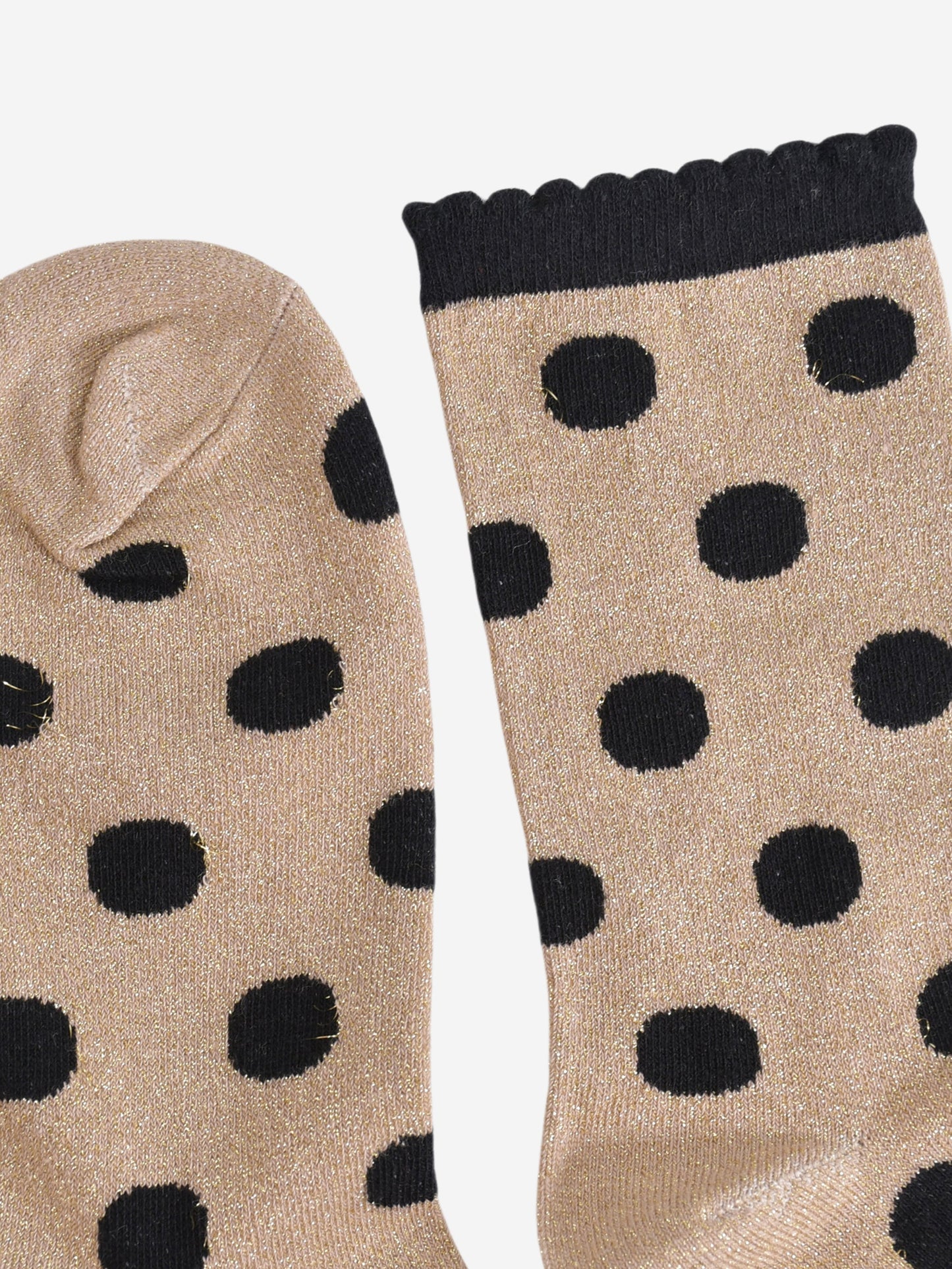close up of the toe and cuff, the toe is gold with silver sparkles like the base of the socks, the cuff is black and has a scalloped edge