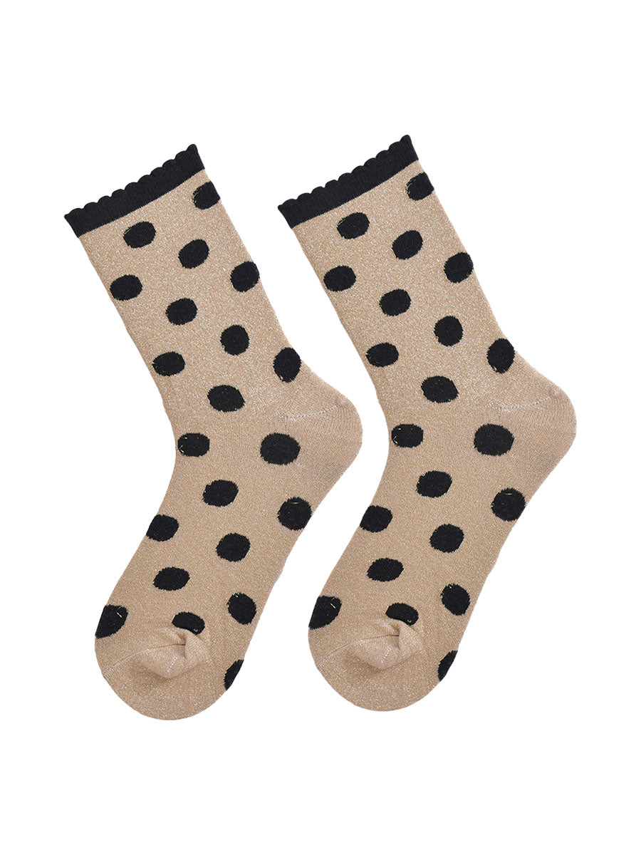 showing the gold and black polka dot socks laying flat, the silver glitter sparkle is visible and the black polka dot pattern is all over the design