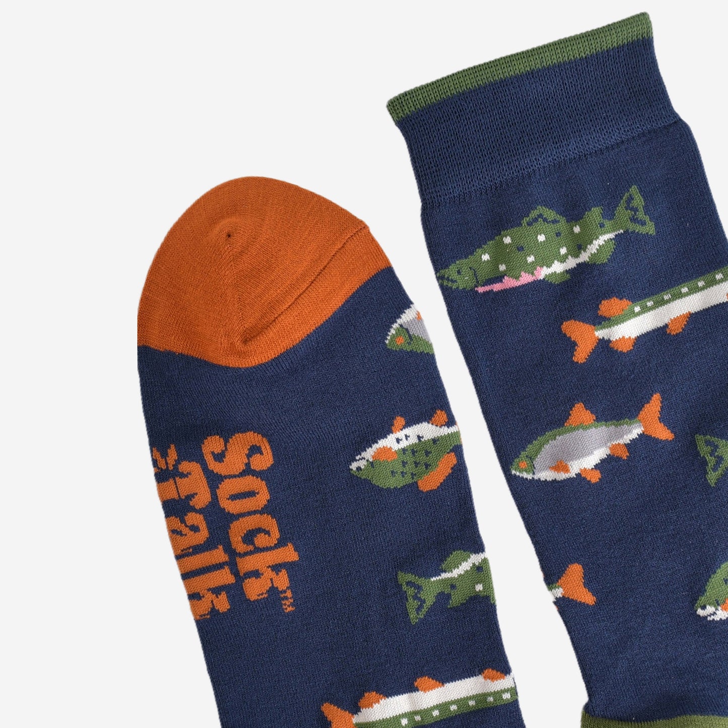 close up of the cuff and toe of the socks, the cuff has a thin green stripe on the edge and the toe is orange, both in contrast to the navy blue colour of the socks