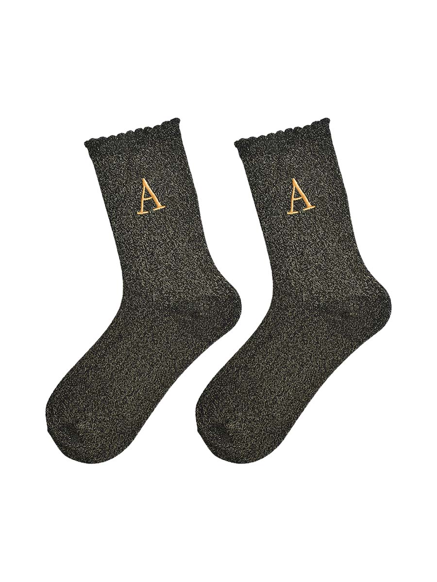 showing the glitter socks laying flat, they have a scalloped cuff and an all over gold sparkle