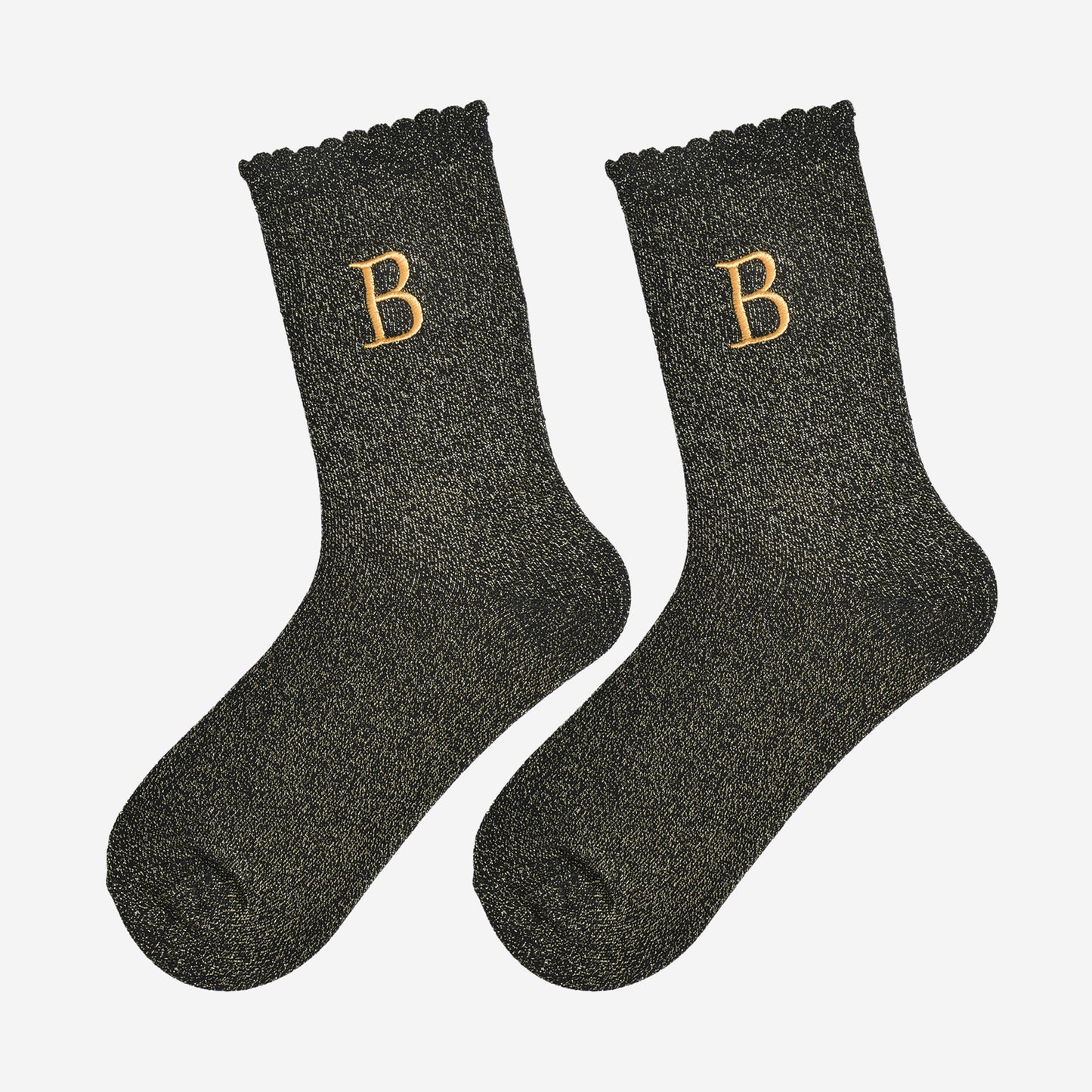 showing the glitter socks laying flat, they have a scalloped cuff and an all over gold sparkle