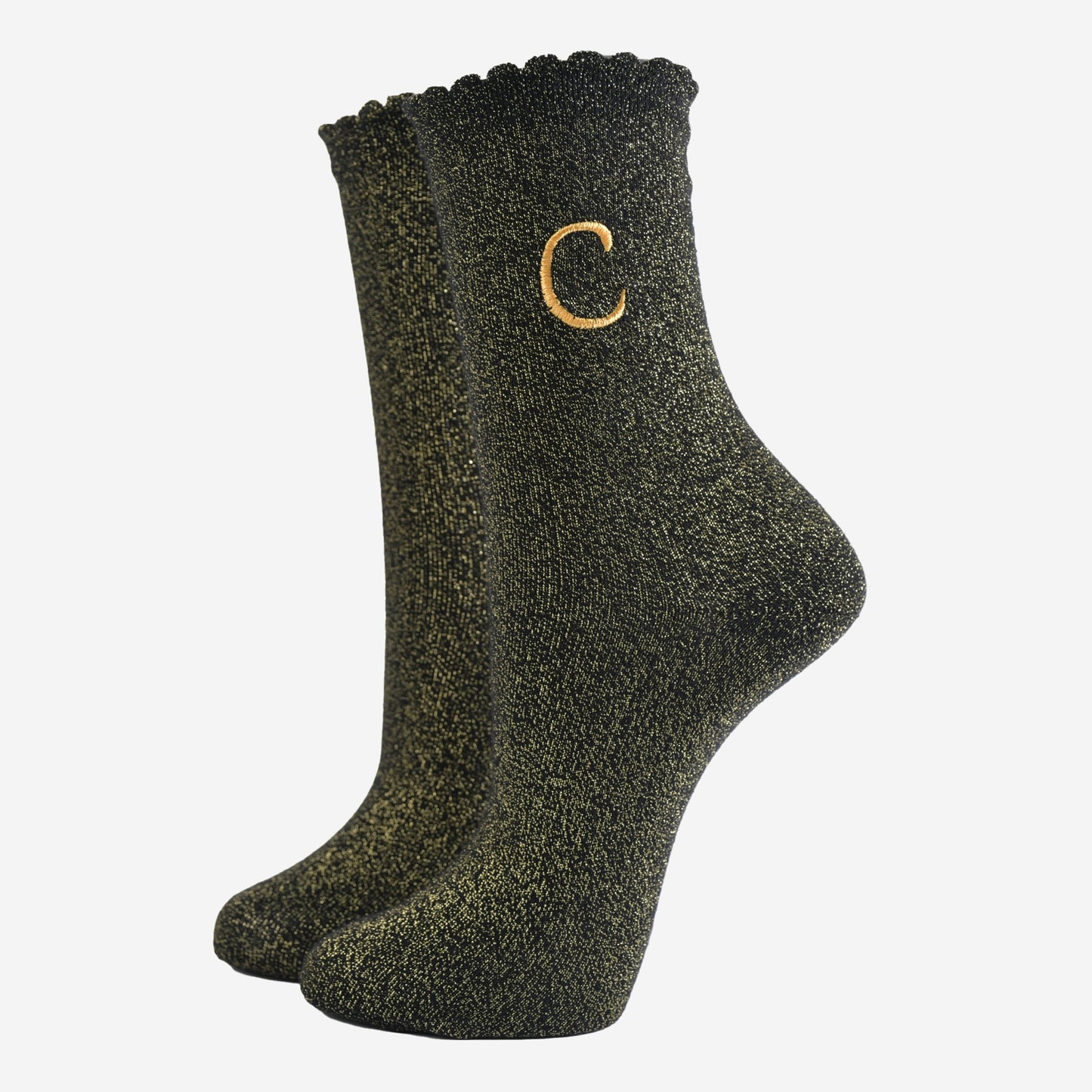 black ankle socks with a scalloped cuff, with an all over gold glitter sparkle and an embroidered gold letter c on the ankle