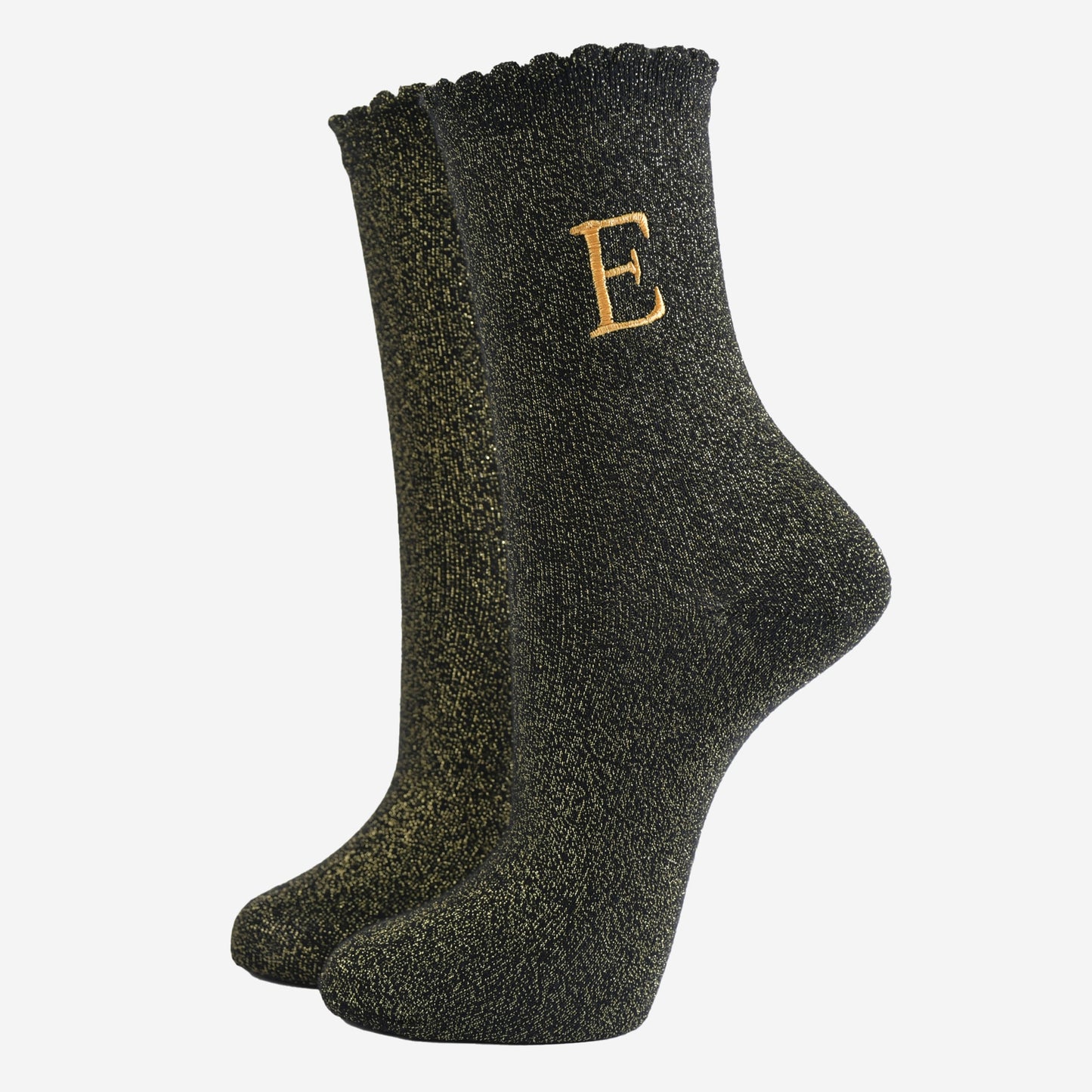 black ankle socks with a scalloped cuff, with an all over gold glitter sparkle and an embroidered gold letter e on the ankle