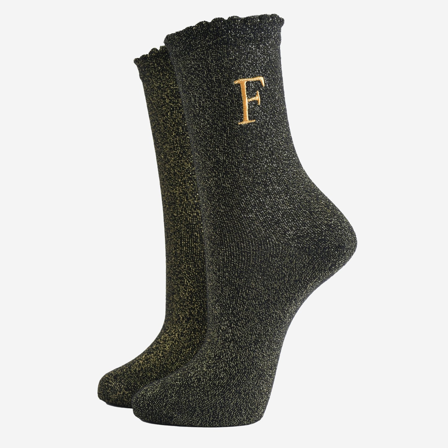 black ankle socks with a scalloped cuff, with an all over gold glitter sparkle and an embroidered gold letter f on the ankle