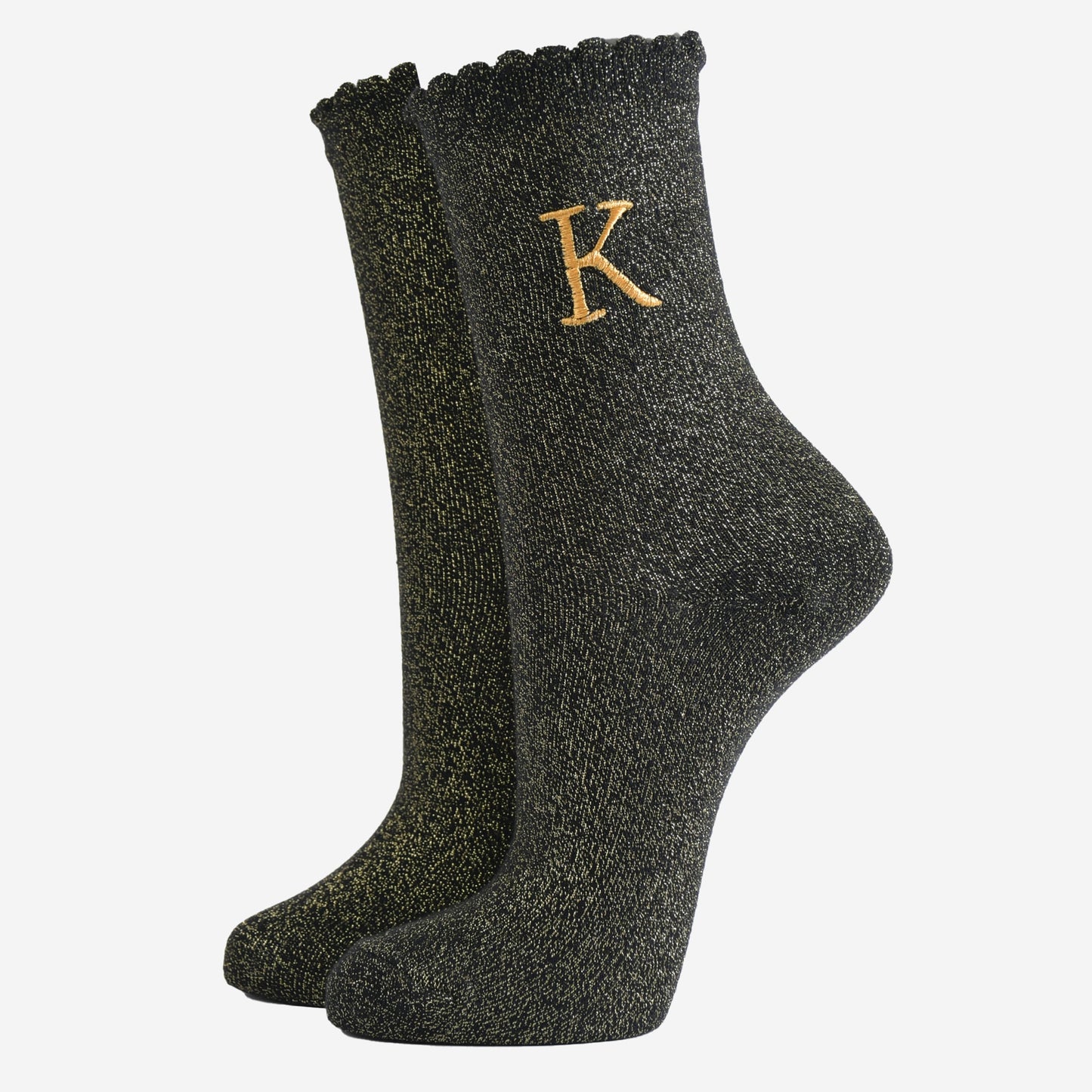 black ankle socks with a scalloped cuff, with an all over gold glitter sparkle and an embroidered gold letter k on the ankle