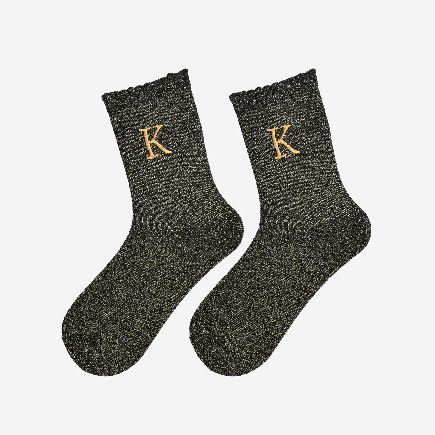 showing the glitter socks laying flat, they have a scalloped cuff and an all over gold sparkle