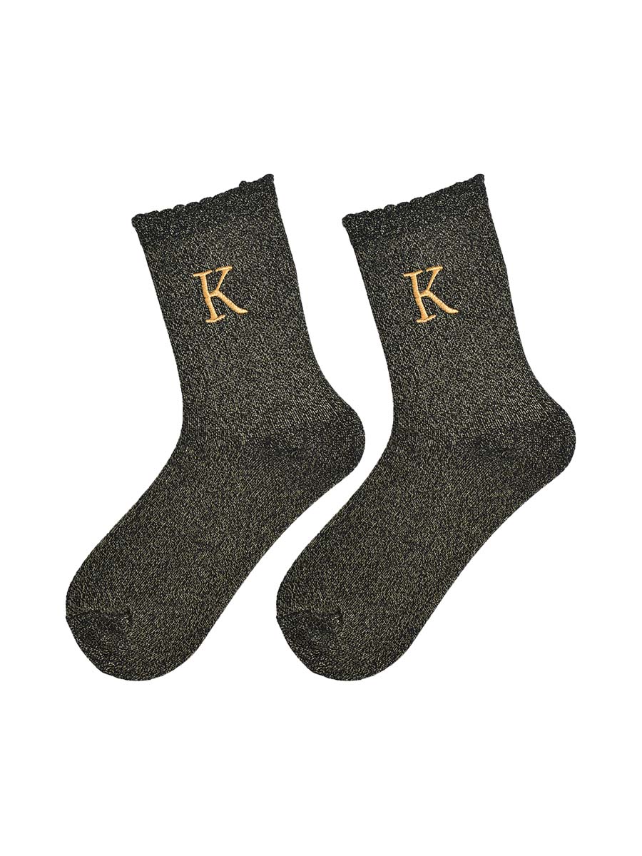 showing the glitter socks laying flat, they have a scalloped cuff and an all over gold sparkle